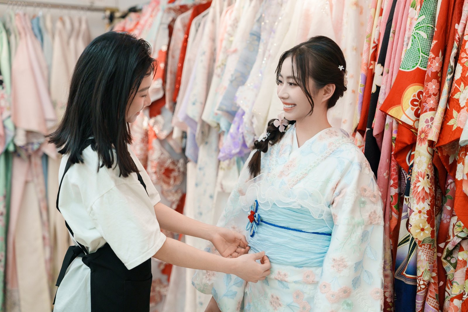 Staff helping a guest into her kimono at ANN