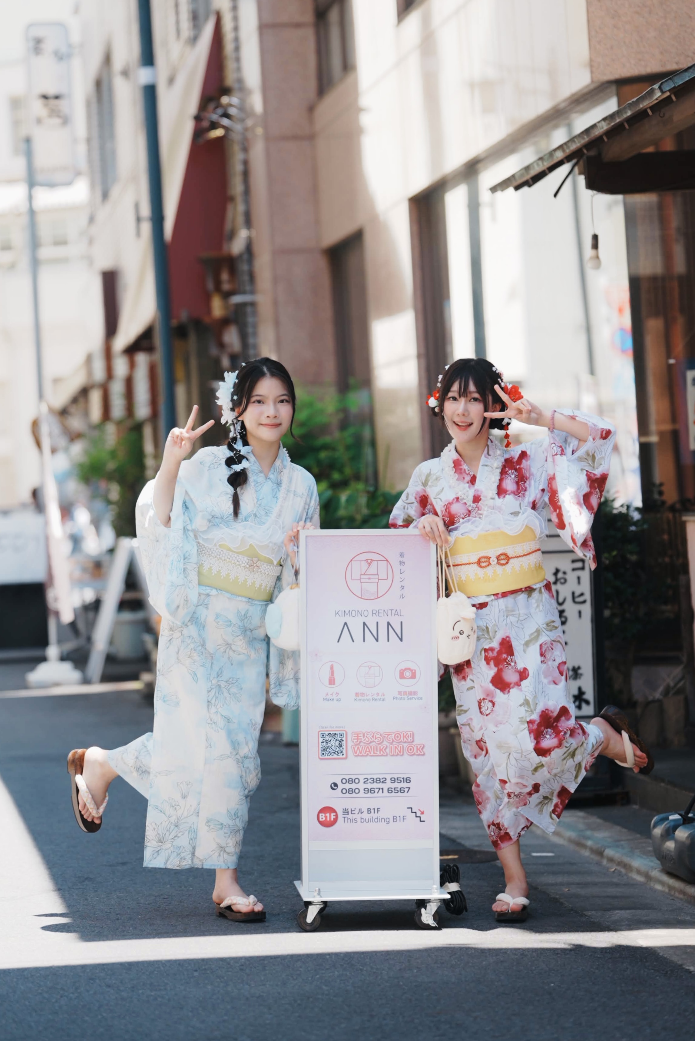 Guests posing at the ANN storefront sign in Asakusa