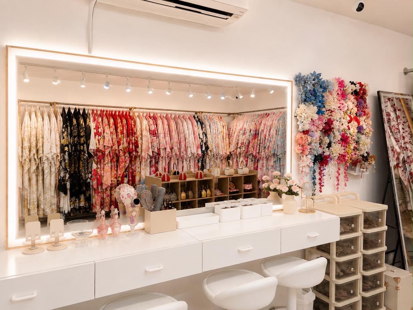 Vanity counter with lit mirror and hair accessory wall